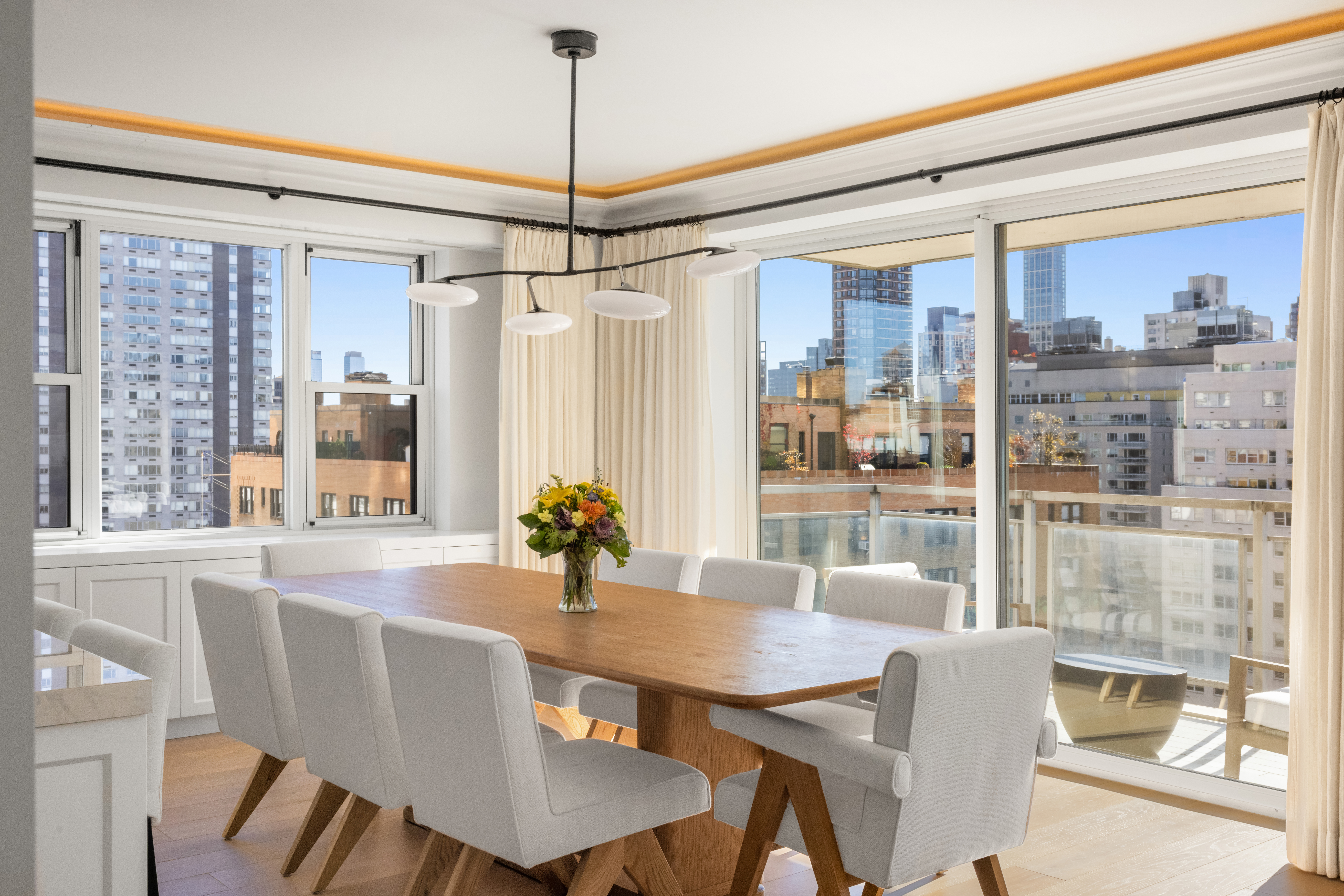 150 East 69th Street, Unit 18S Manhattan, NY 10021 - Photo 4 of 16 a view of a dining room with furniture window and outside view