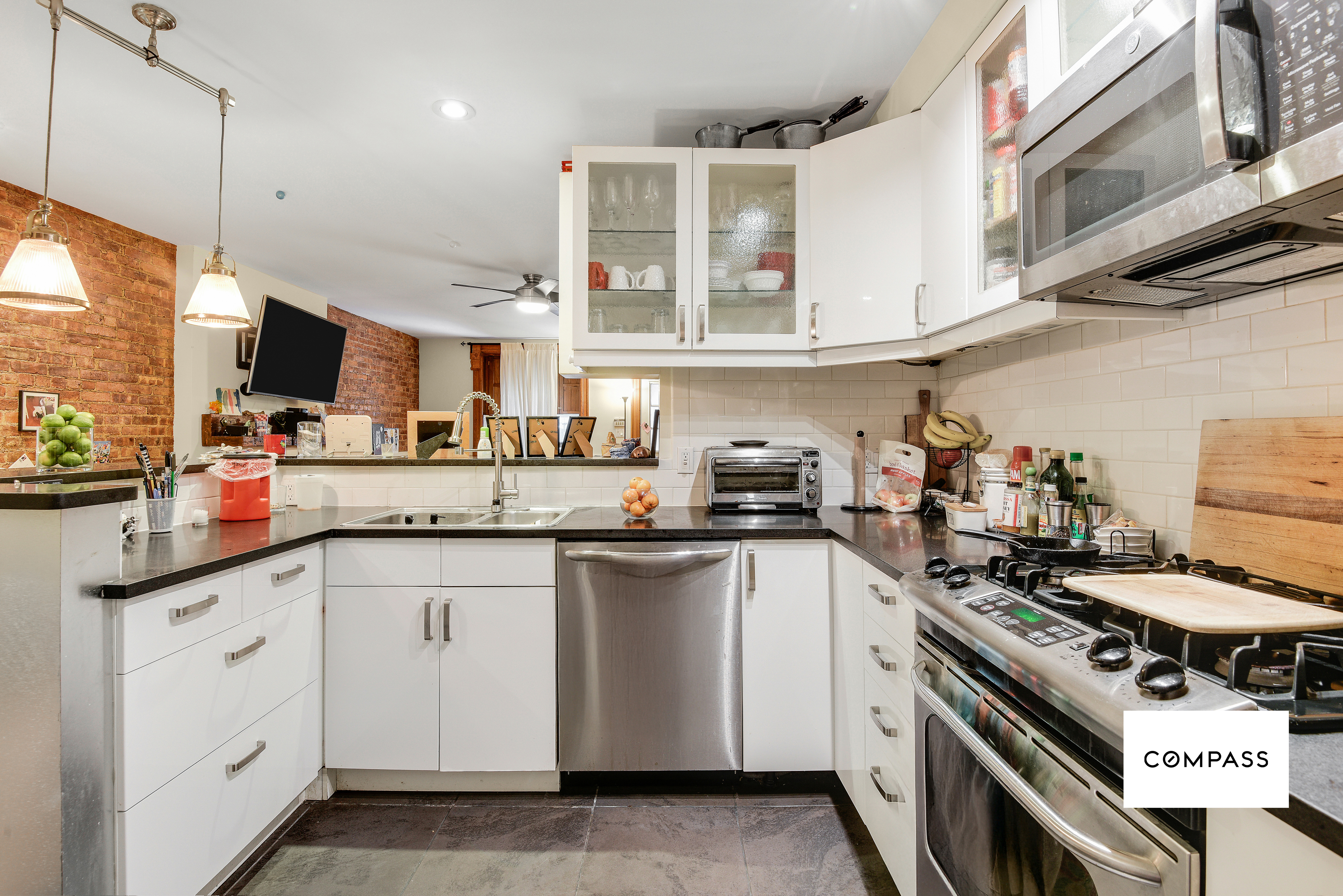 347 West 121st Street Manhattan, NY 10027 - Photo 4 of 10 a kitchen with stainless steel appliances granite countertop a stove and a sink