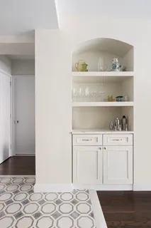 a bedroom with a bed and cabinets