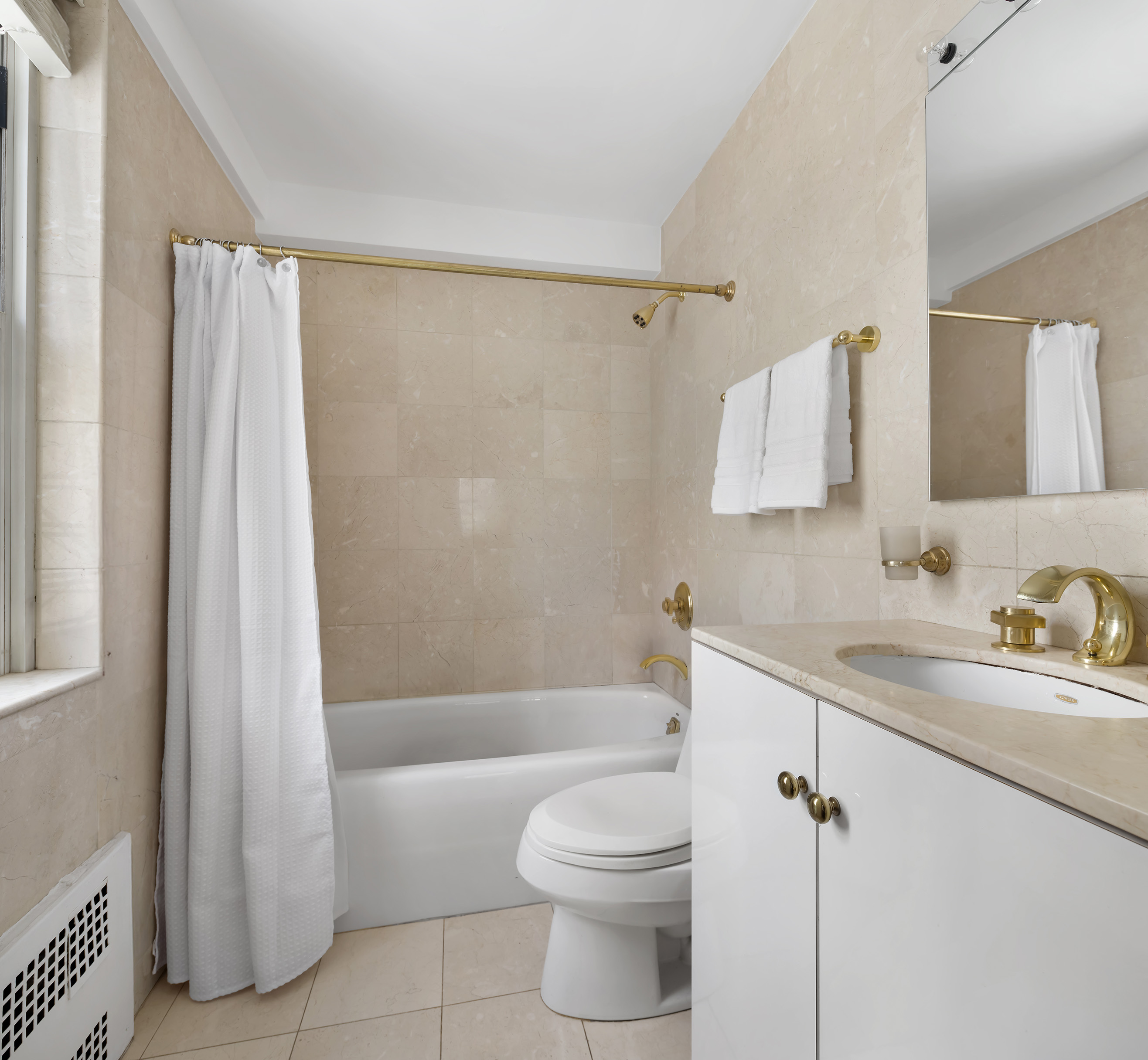 710 Park Avenue, Unit 5F Manhattan, NY 10021 - Photo 8 of 11 a bathroom with a sink a toilet and shower