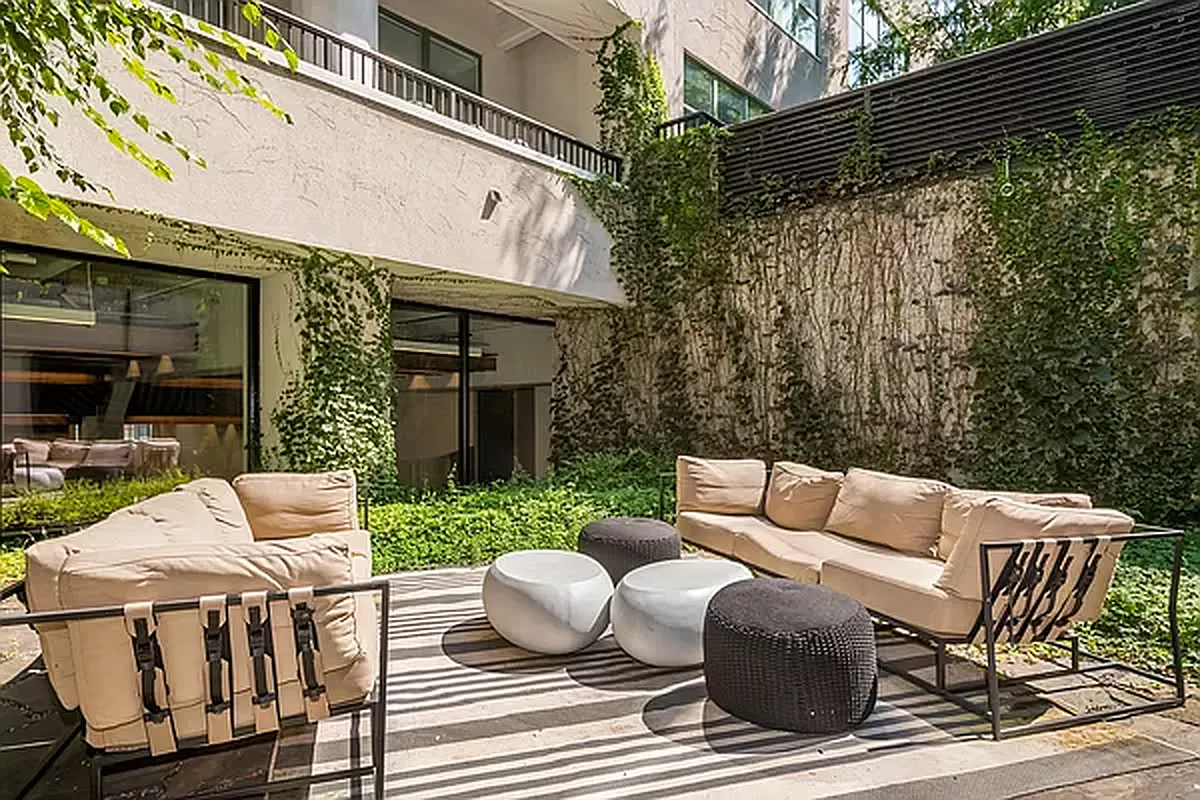 184 Kent Avenue, Unit B407 Brooklyn, NY 11249 - Photo 9 of 14 a view of a patio with a table and chairs and couches