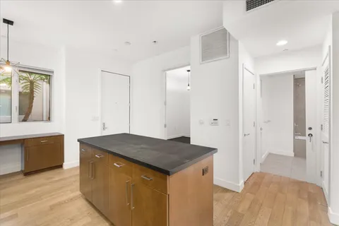a en suite bathroom with a granite countertop sink and a mirror