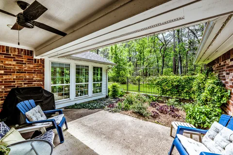 a view of a chair and table in backyard of the house