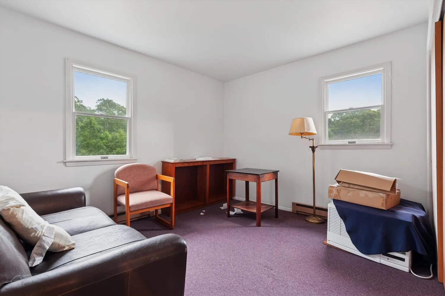 a living room with furniture a ceiling fan and a window