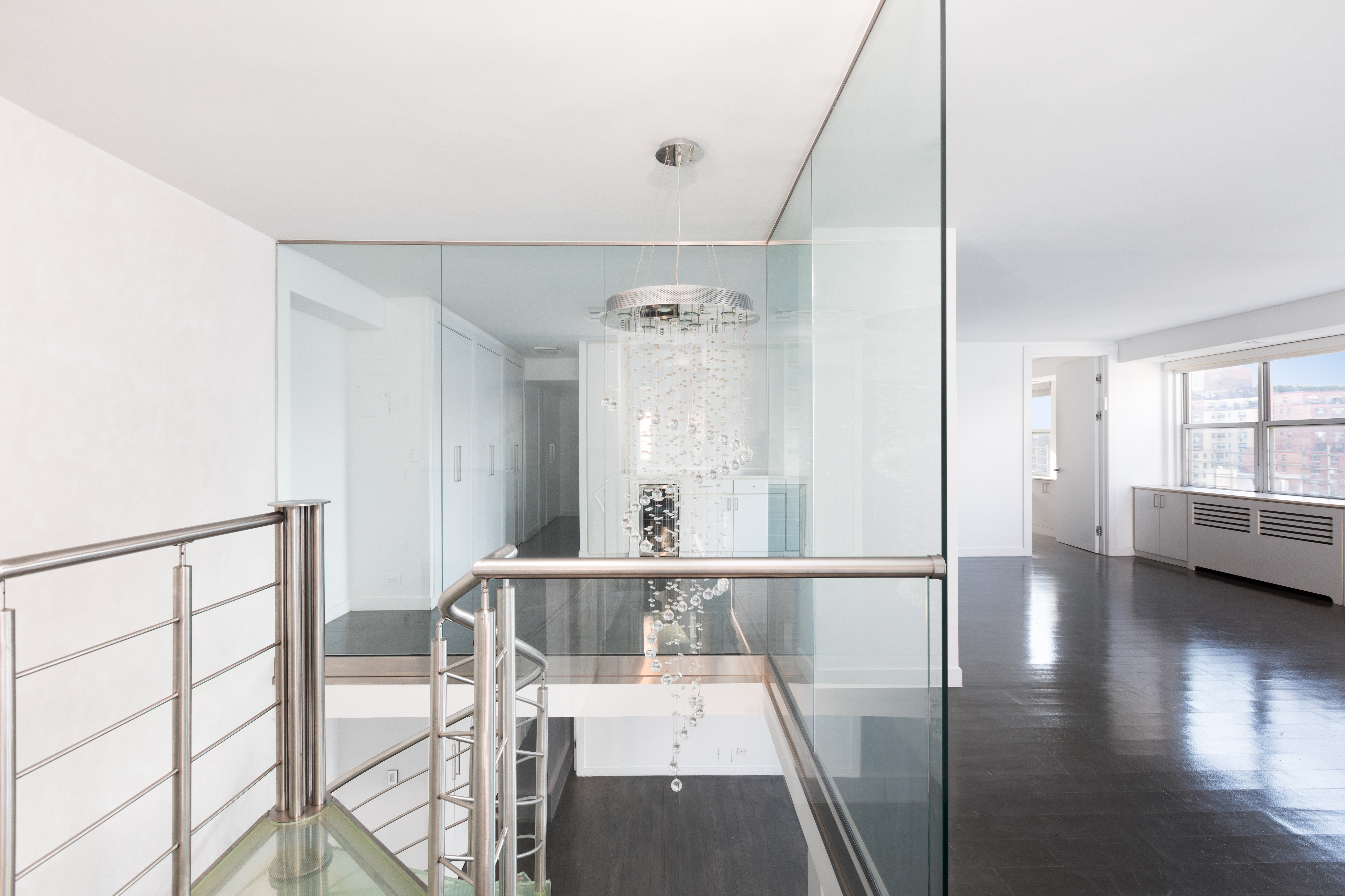 401 East 74th Street, Unit 20F Manhattan, NY 10021 - Photo 6 of 22 a view of a hallway with wooden floor and windows