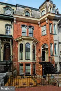 a front view of a brick building with many windows