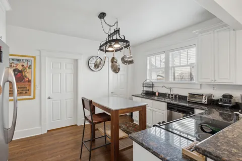 a view of a dining room with furniture wooden floor and chandelier
