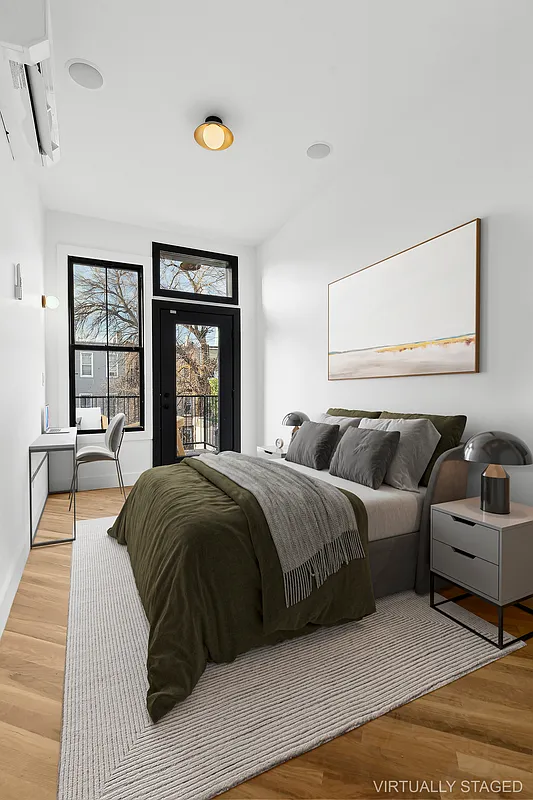 1265 Madison Street, Unit 2 Brooklyn, NY 11221 - Photo 6 of 9 a spacious bedroom with a bed and a large window