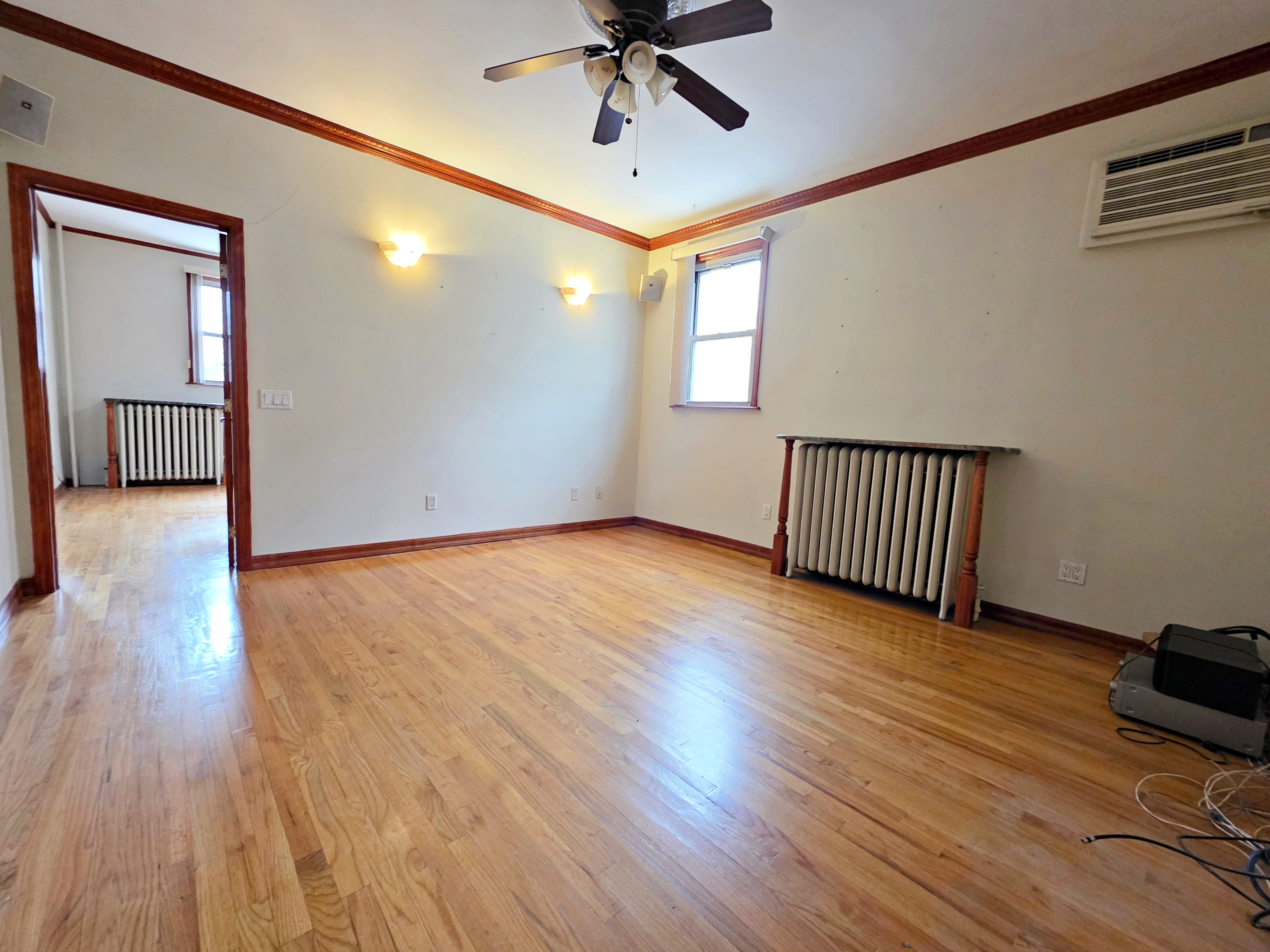 714 Lorimer Street, Unit 1 Brooklyn, NY 11211 - Photo 7 of 7 wooden floor in an empty room with a window