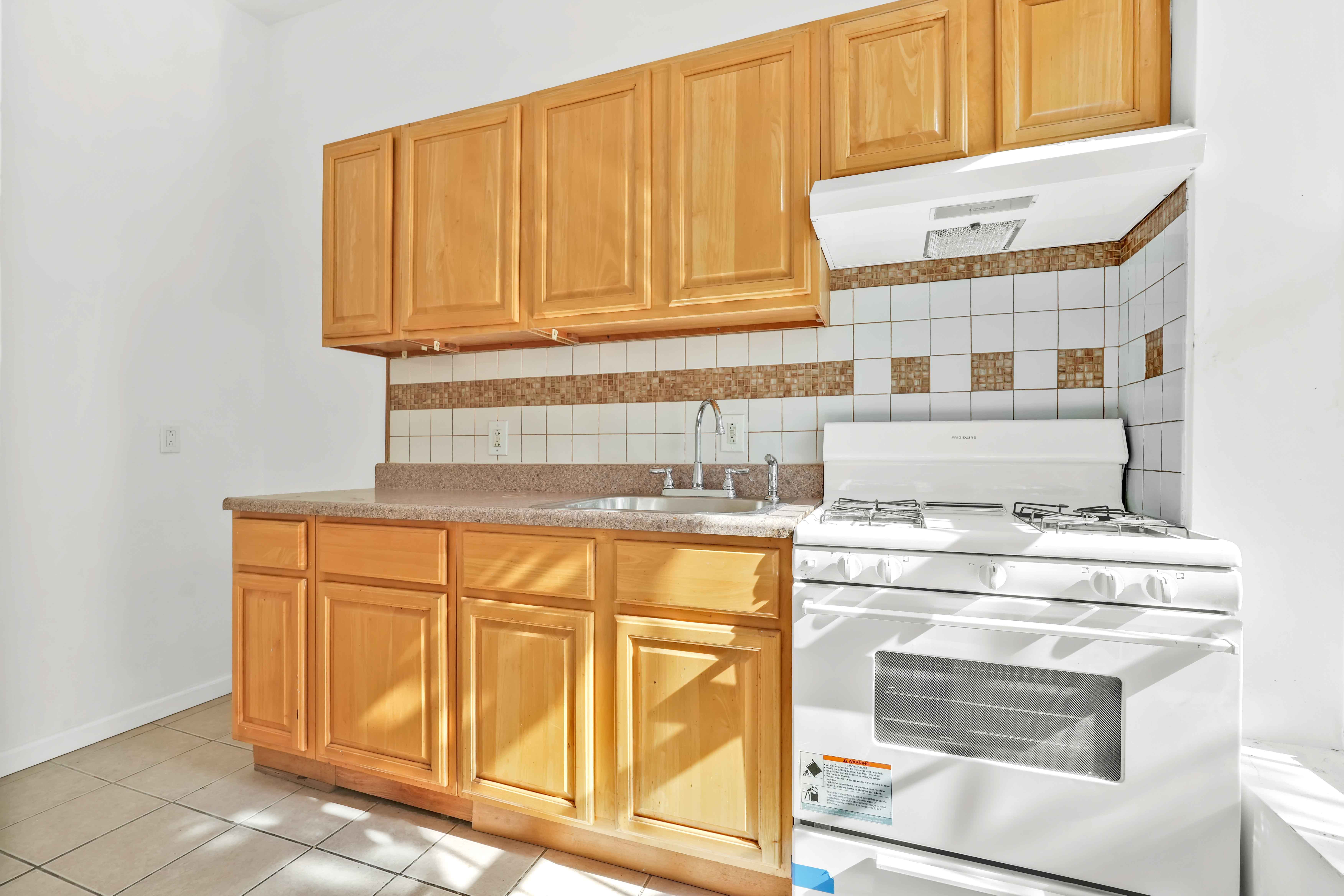 238 Vernon Avenue, Unit 2 Brooklyn, NY 11206 - Photo 11 of 21 a kitchen with granite countertop cabinets stainless steel appliances and a counter space