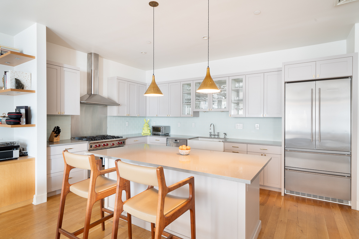 481 Washington Street, Unit 6N Manhattan, NY 10013 - Photo 2 of 10 a kitchen with stainless steel appliances a stove a sink a center island and a refrigerator