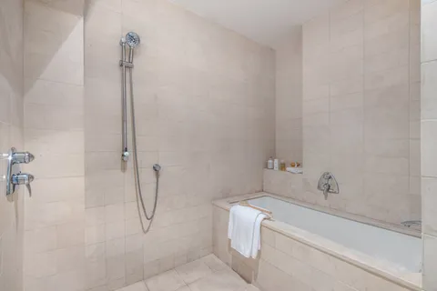 a bathroom with a bath tub with a shower