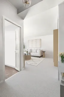 a view of a bedroom with a large bed and mirror