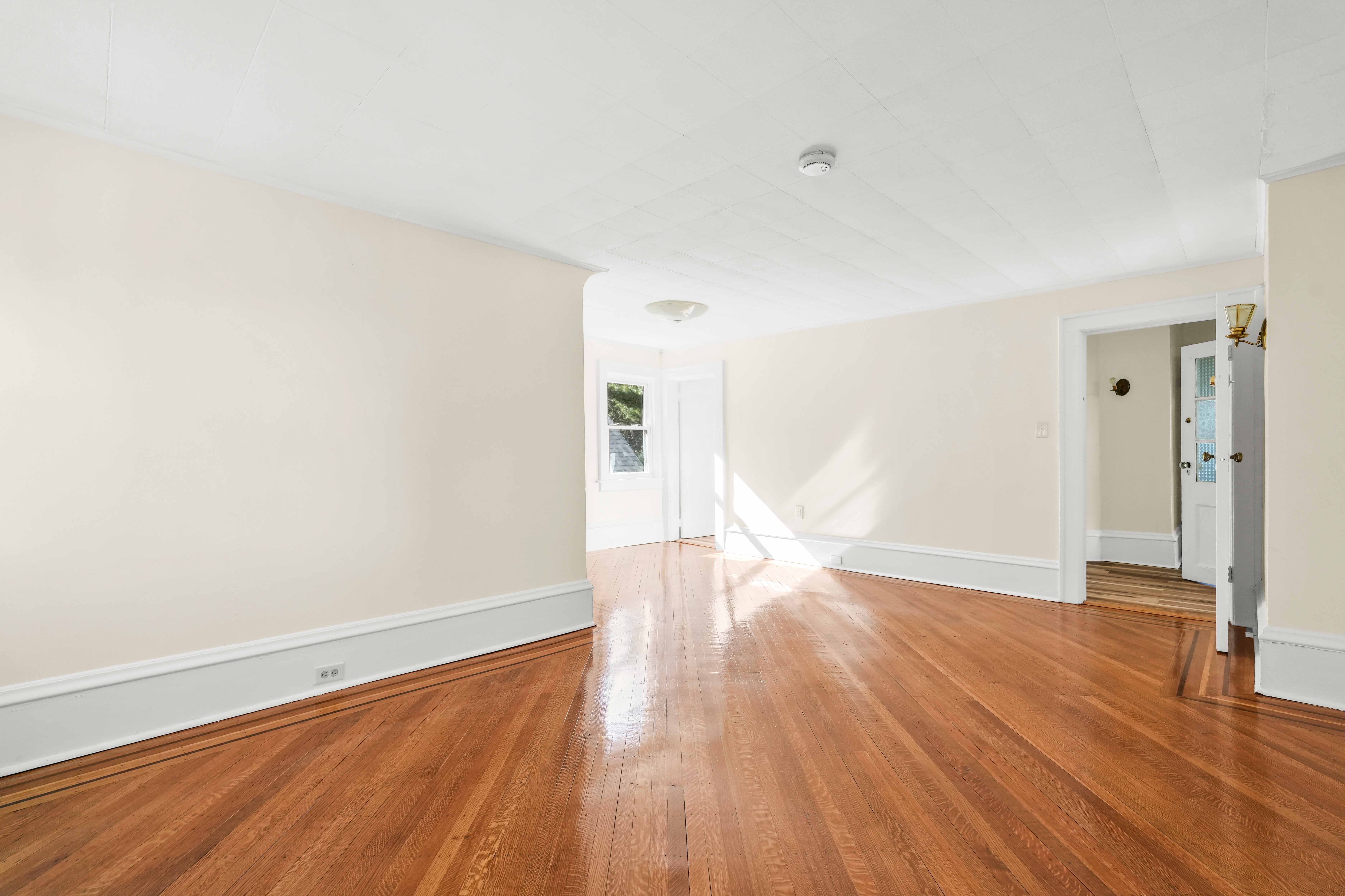 642 East 26th Street Brooklyn, NY 11210 - Photo 23 of 32 a view of empty room with wooden floor and fan