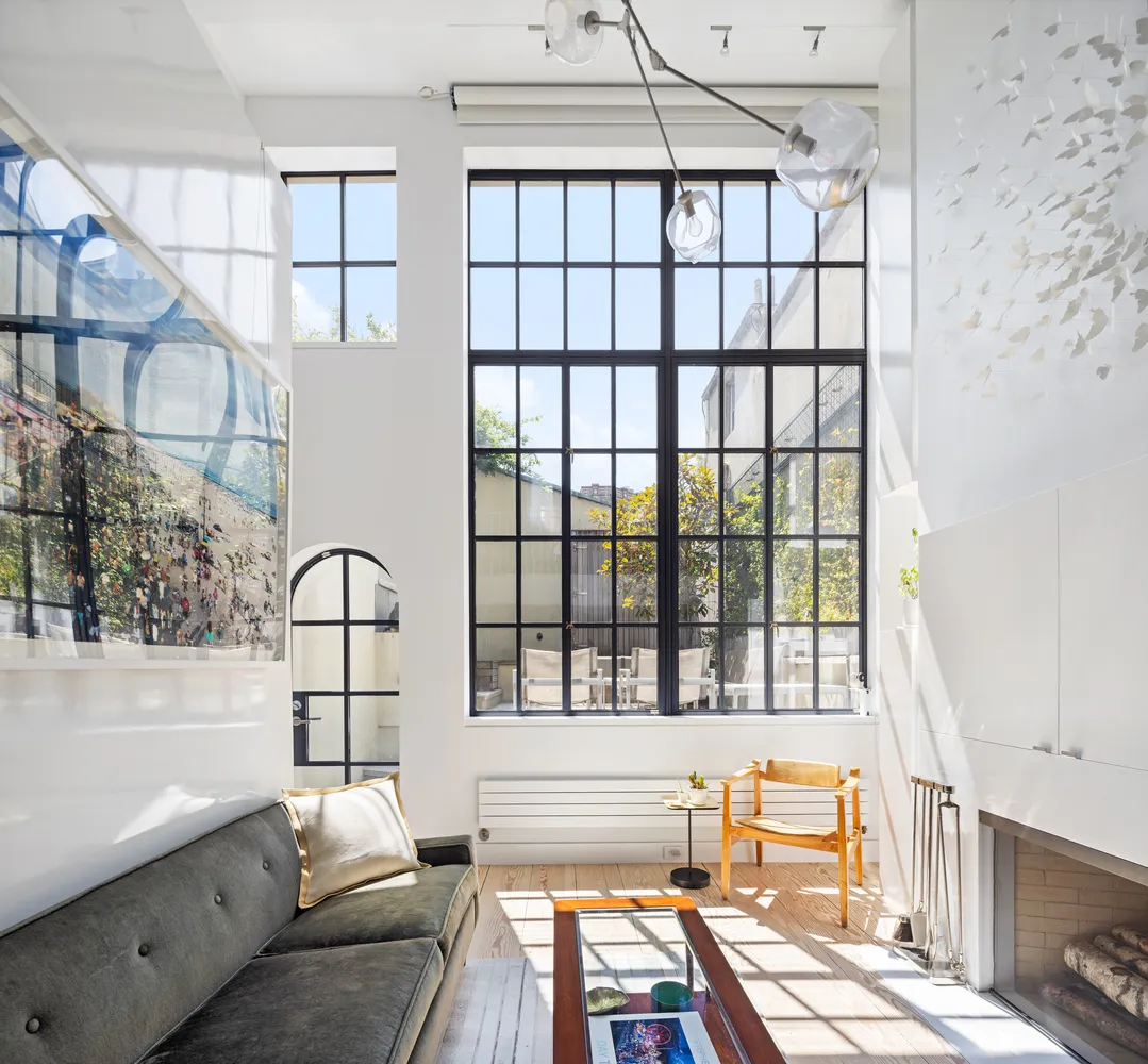 a view of a living room filled with furniture and a window