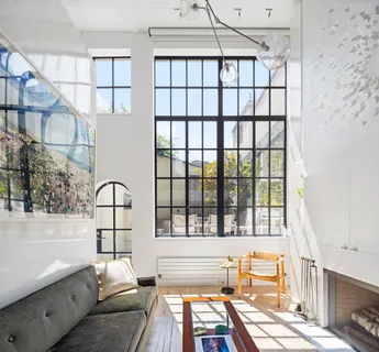 a view of a living room filled with furniture and a window