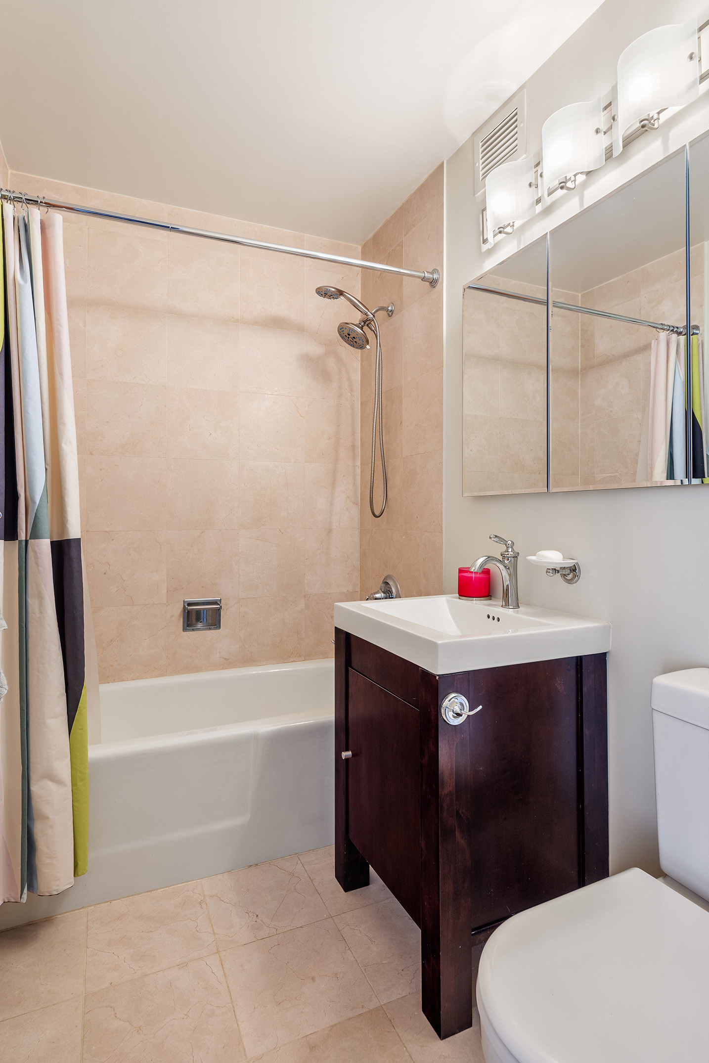 300 East 90th Street, Unit 7C Manhattan, NY 10128 - Photo 8 of 12 a bathroom with a sink vanity mirror and toilet