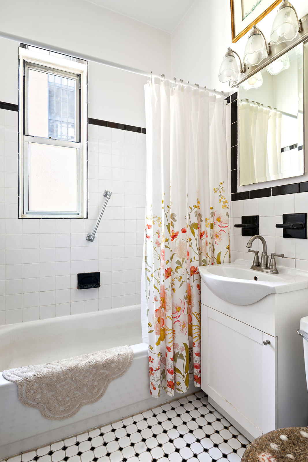 225 East 47th Street, Unit 6H Manhattan, NY 10017 - Photo 4 of 6 a bathroom with a sink toilet and shower
