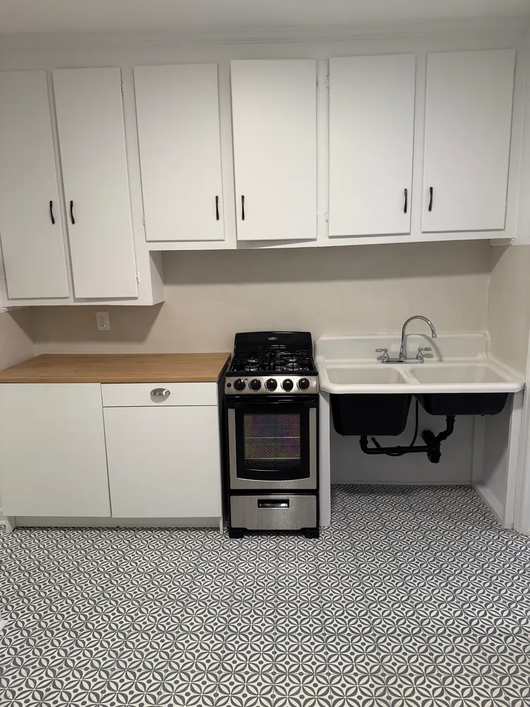 a kitchen with a sink and cabinets
