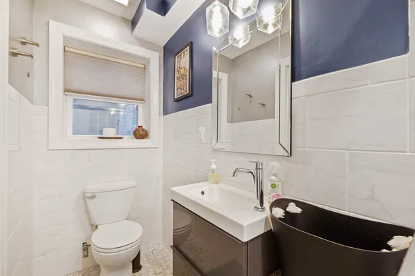 a bathroom with a sink a toilet and a mirror