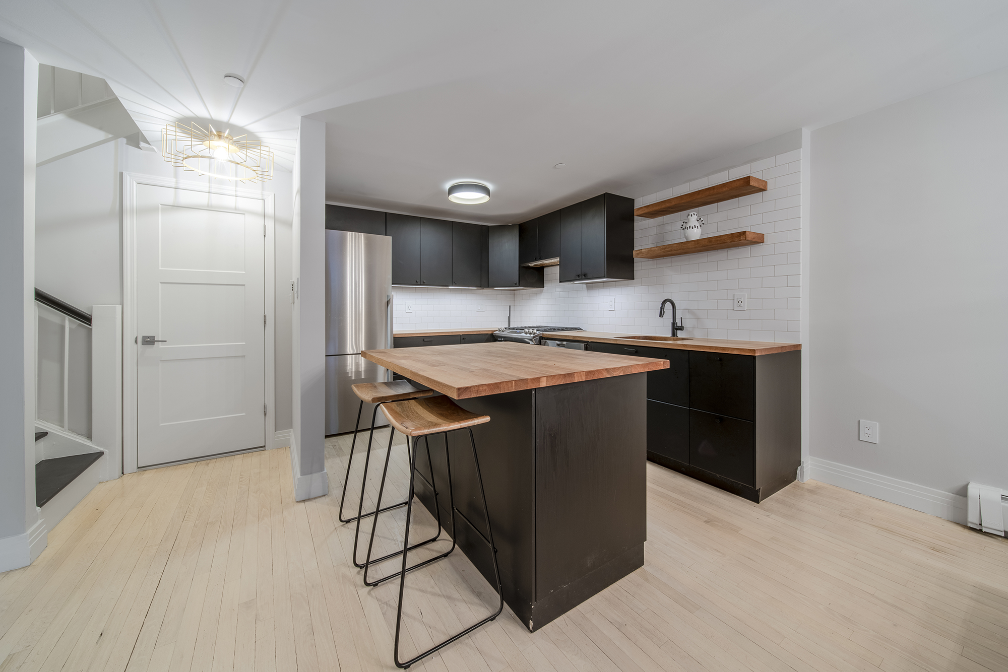 407 East 12th Street, Unit 1RSE Manhattan, NY 10009 - Photo 5 of 13 a kitchen with stainless steel appliances granite countertop a sink a stove a refrigerator and island