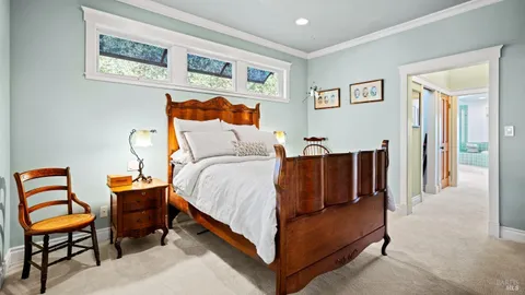 a bedroom with furniture and a lamp