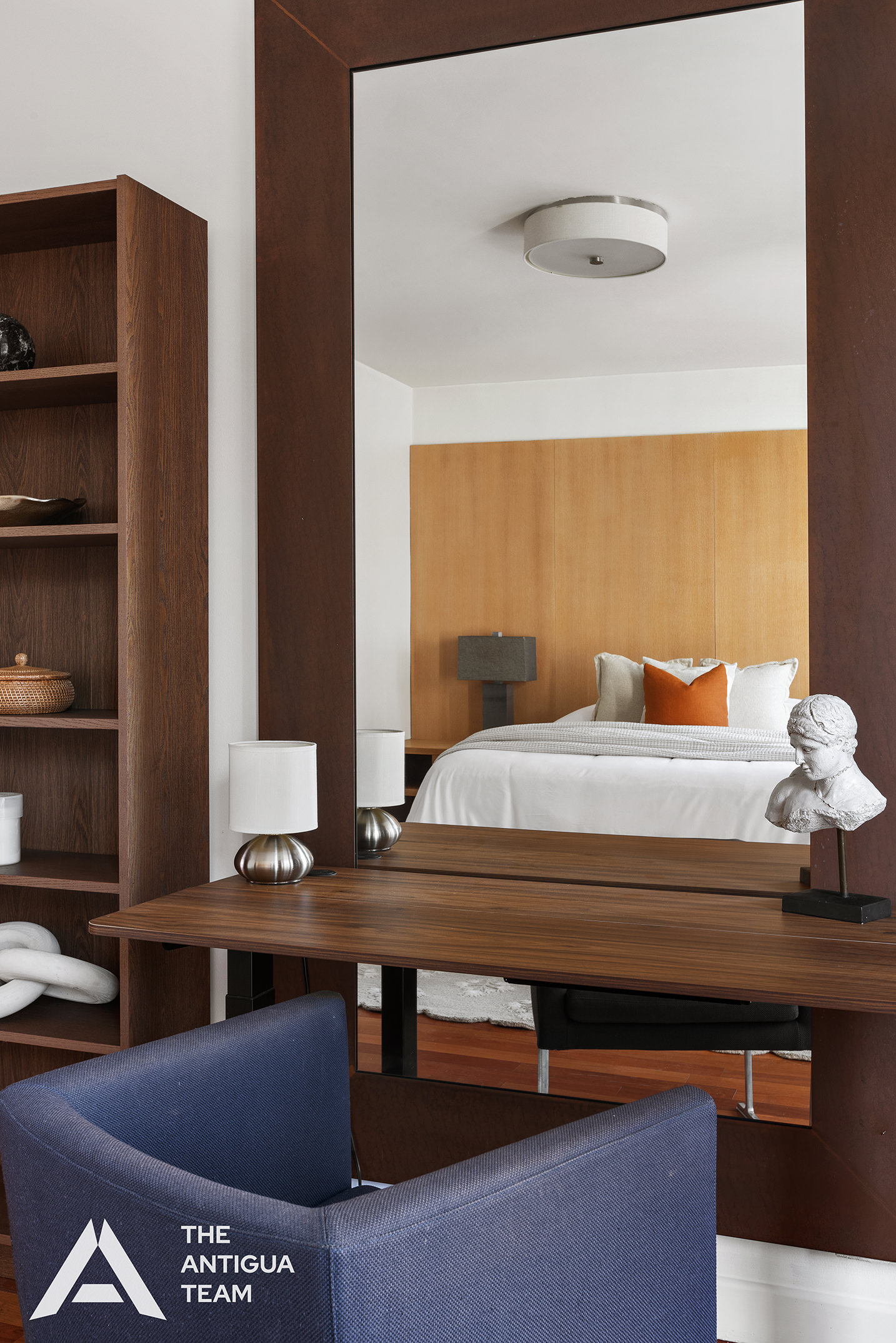 125 West 21st Street, Unit 12A Manhattan, NY 10011 - Photo 8 of 16 a bedroom with a bed and a bookshelf