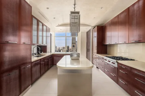 a kitchen with granite countertop a sink stainless steel appliances and cabinets