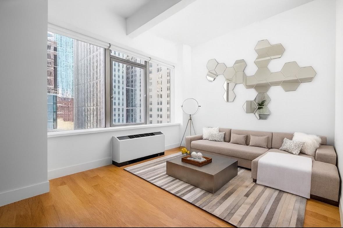 50 Murray Street, Unit 603 Manhattan, NY 10007 - Photo 1 of 3 a living room with furniture and a large window
