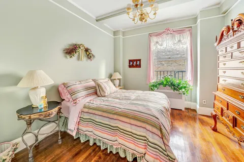 a bedroom with a bed and a chandelier