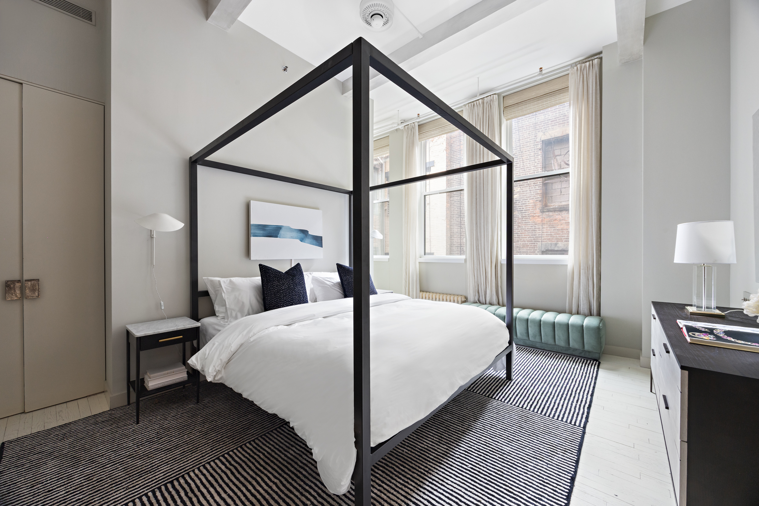 32 West 20th Street, Unit 5 Manhattan, NY 10011 - Photo 10 of 18 a bedroom with a bed table and two large window