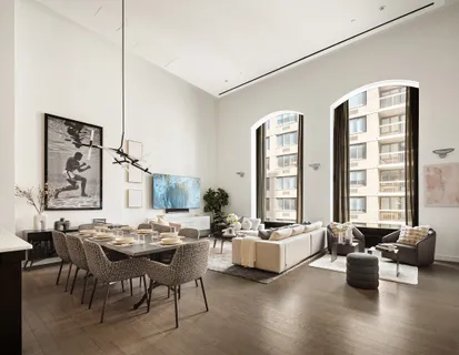 a living room with furniture and large windows