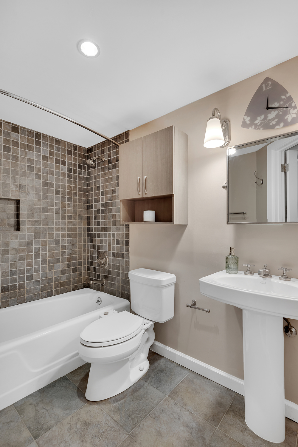 41 East 19th Street, Unit 1B Manhattan, NY 10003 - Photo 7 of 8 a bathroom with a toilet a sink a mirror a bathtub and shower