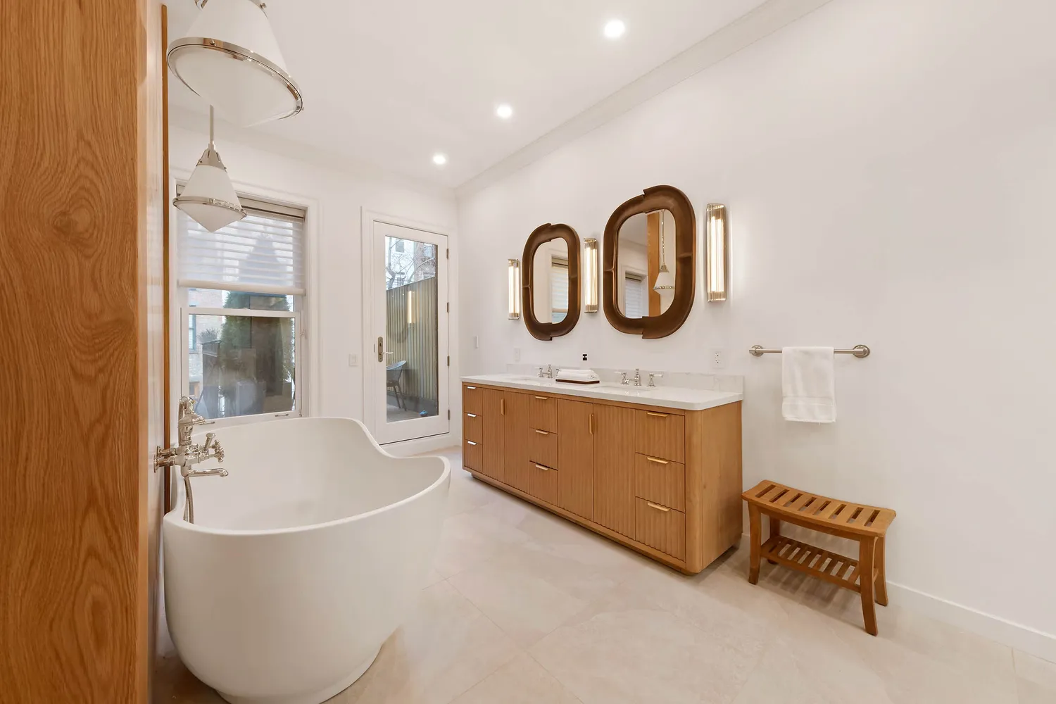 a bathroom with a tub sink and mirror