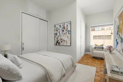 a bedroom with a bed and a couch