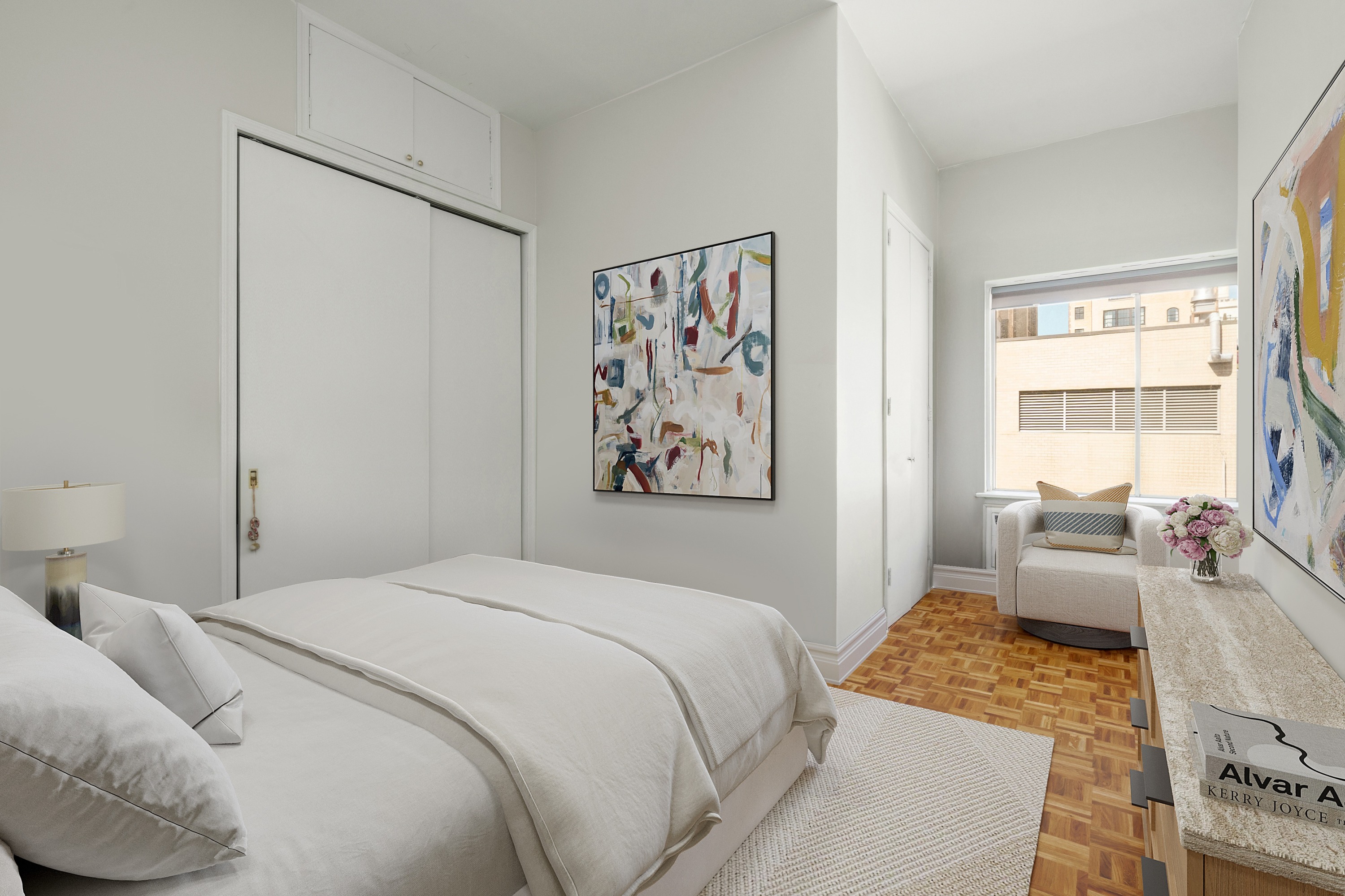 61 East 77th Street, Unit 9C Manhattan, NY 10075 - Photo 9 of 11 a bedroom with a bed and a couch