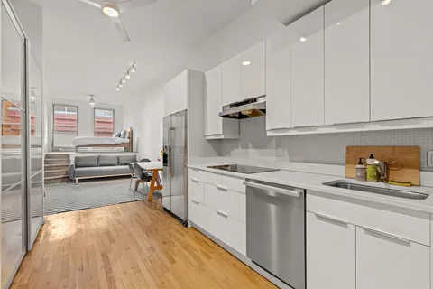 a kitchen with a sink a stove and cabinets