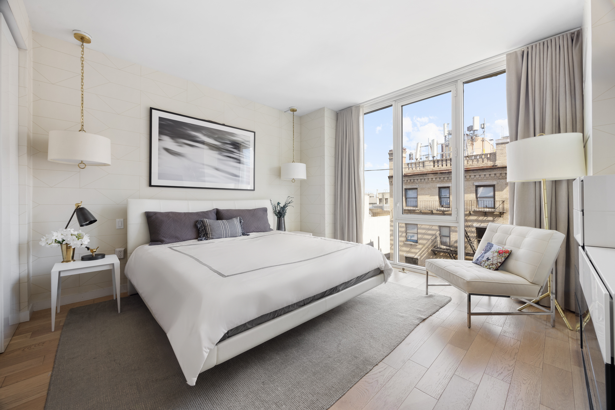 540 West 49th Street, Unit PH1N Manhattan, NY 10019 - Photo 9 of 18 a bedroom with a bed and a couch