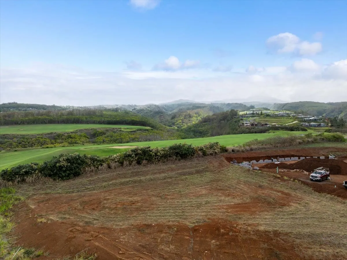 an aerial view of a golf course with parking space