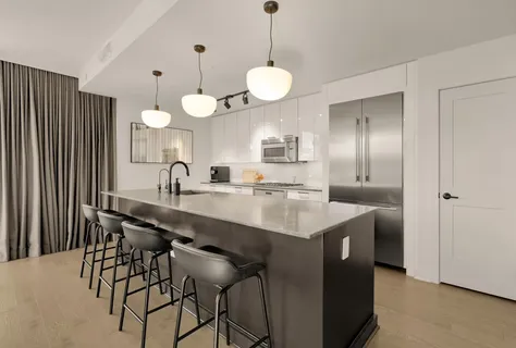 a kitchen with stainless steel appliances a sink and a refrigerator
