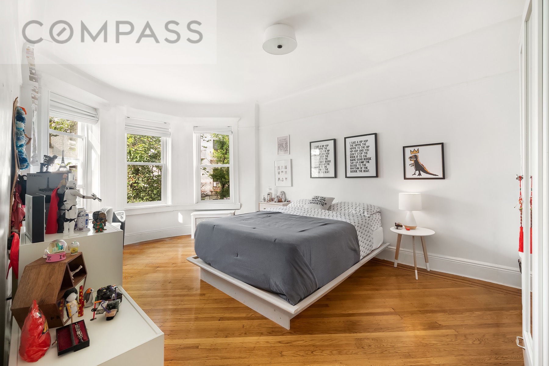 69 Sterling Street Brooklyn, NY 11225 - Photo 7 of 14 a bed room with a bed and a couch