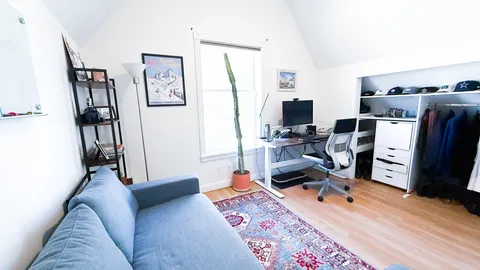 a bedroom with furniture and a flat screen tv