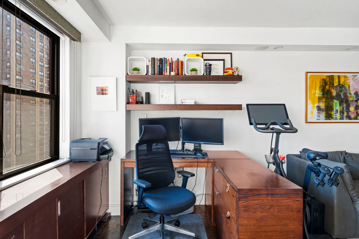 a living room with furniture and a bookshelf