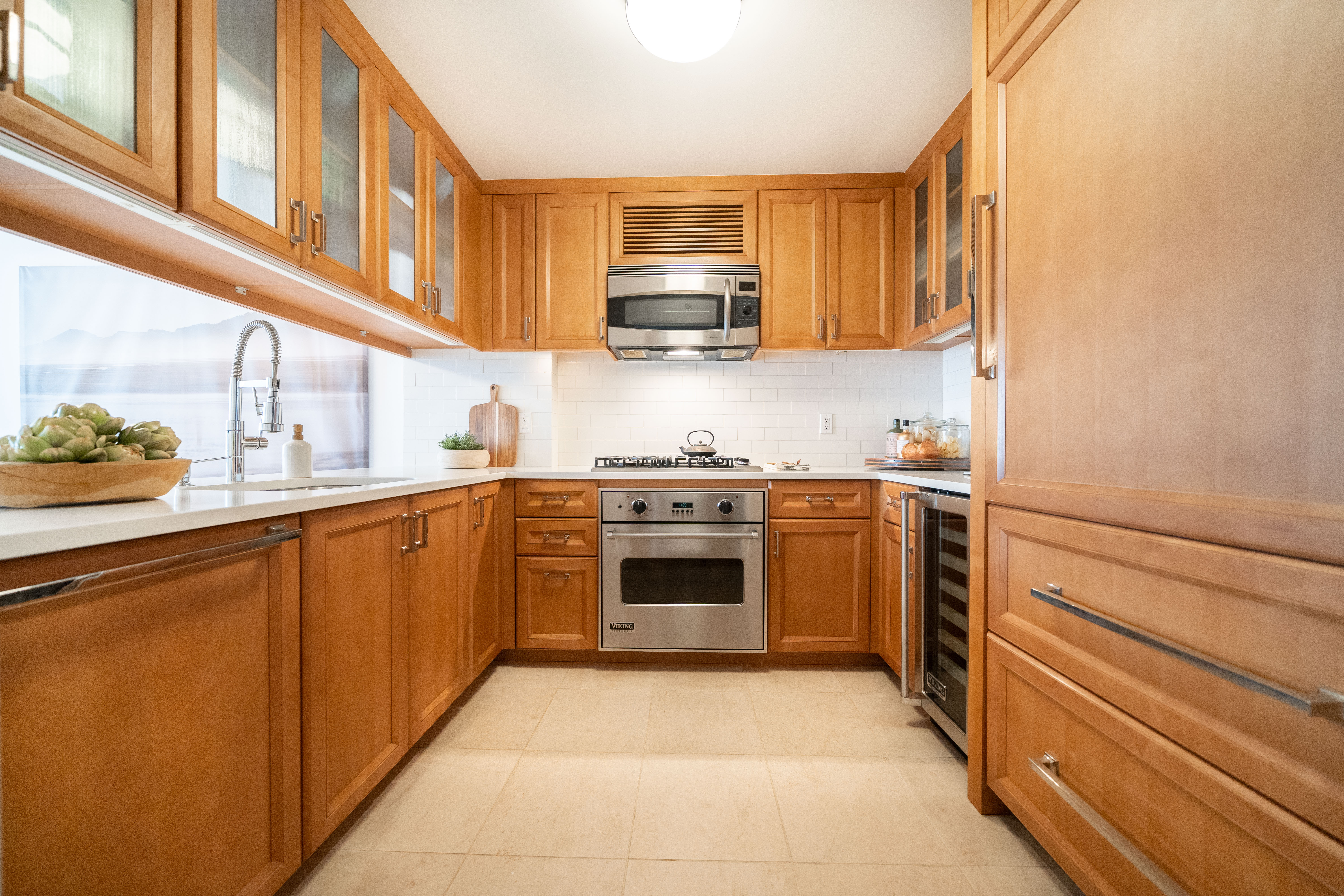 205 East 85th Street, Unit G10 Manhattan, NY 10028 - Photo 7 of 27 a kitchen with a stove top oven sink and cabinets