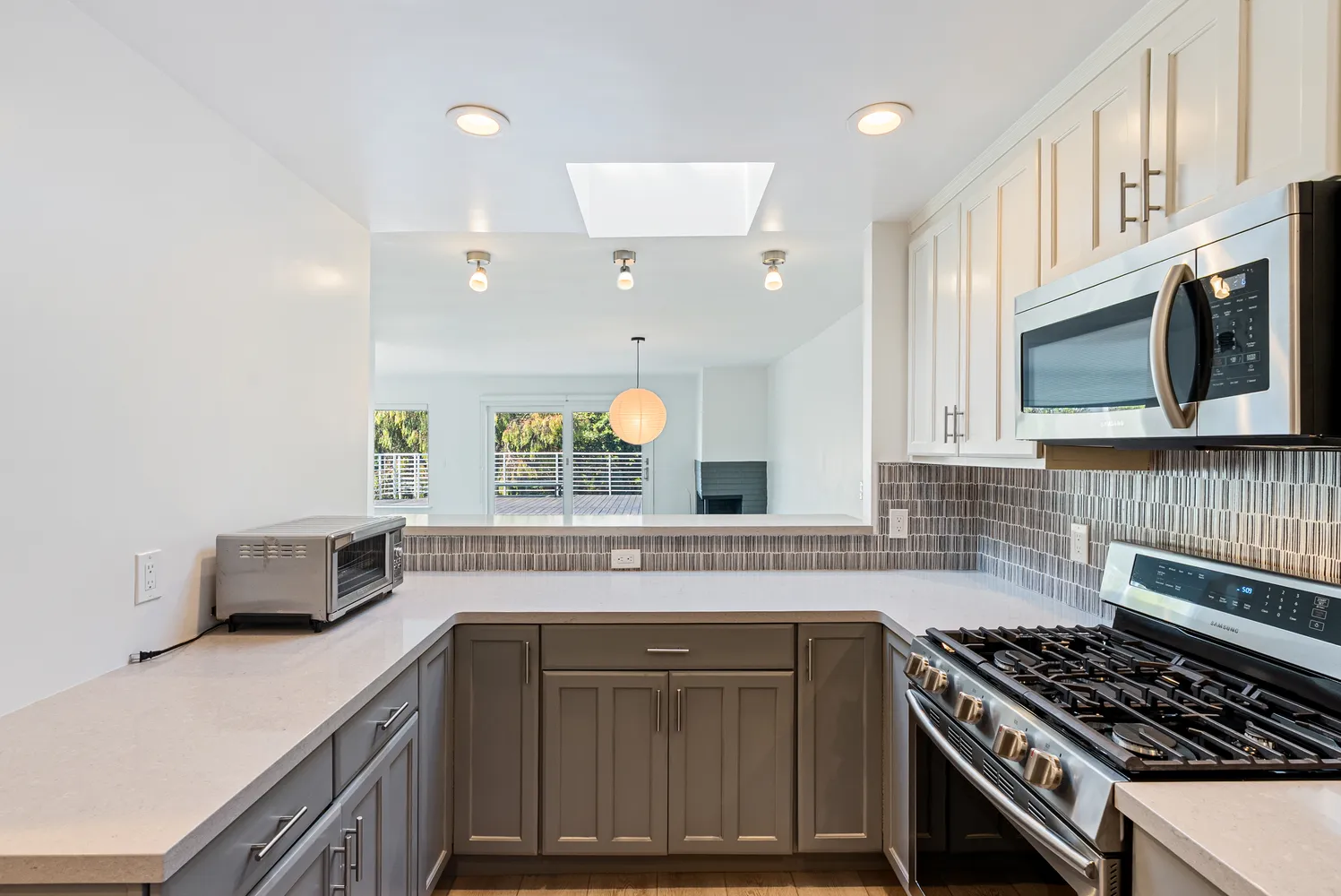 a kitchen with stainless steel appliances a sink stove and cabinets