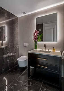 a bathroom with a granite countertop sink a toilet and a mirror