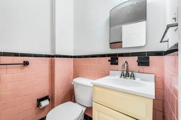 a bathroom with a sink mirror and toilet
