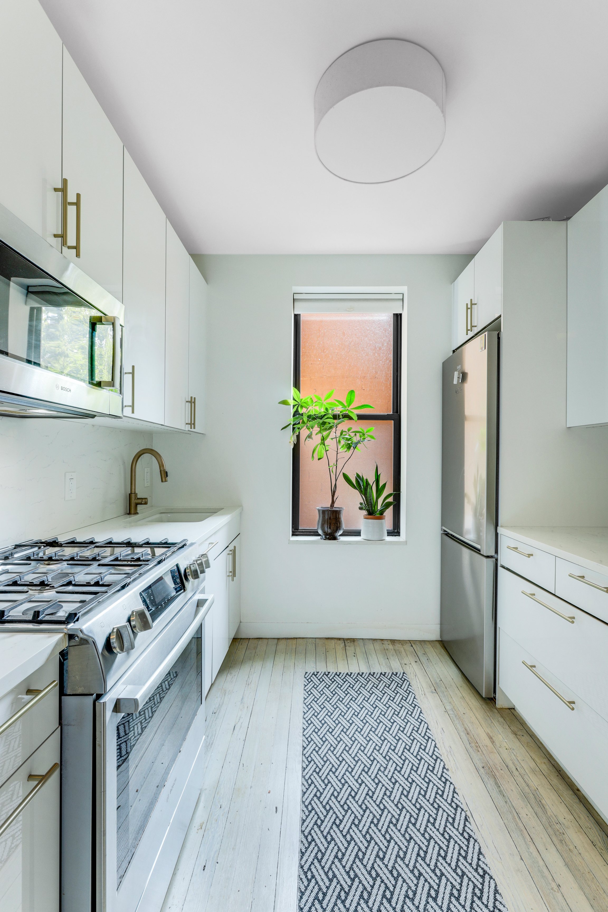 2 Grace Court, Unit 2C Brooklyn, NY 11201 - Photo 3 of 15 a kitchen with stainless steel appliances a stove a refrigerator and a microwave