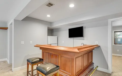 an empty room with windows and television