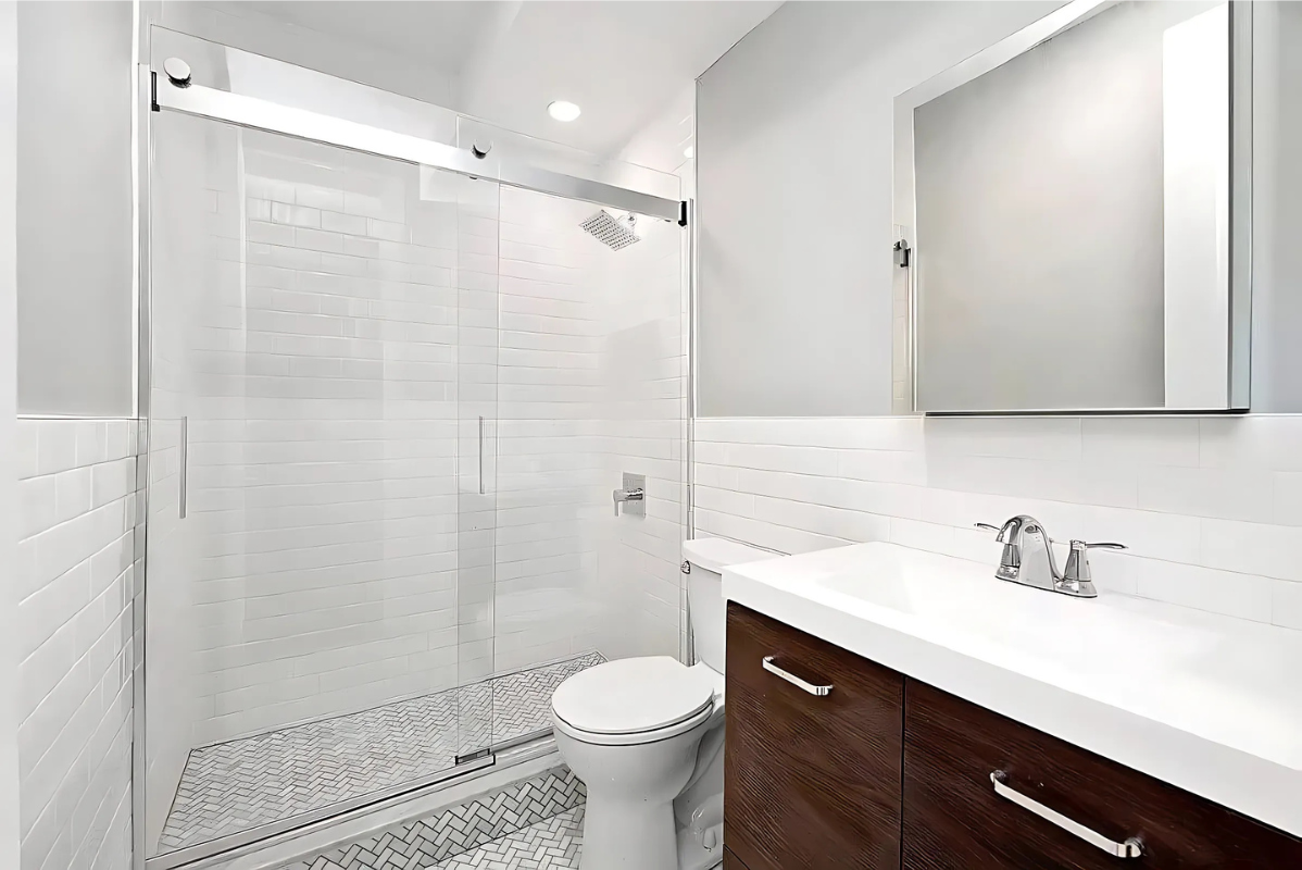 201 West 80th Street, Unit 4W Manhattan, NY 10024 - Photo 9 of 11 a bathroom with a sink a toilet and shower